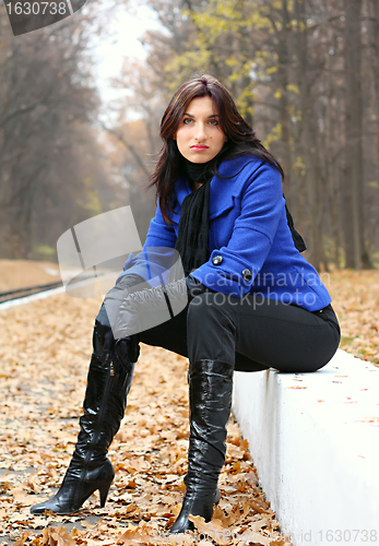 Image of Young woman in the autumn park