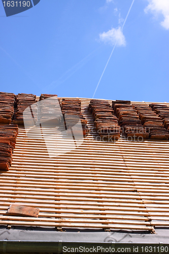 Image of renovation of a tiled roof of an old house