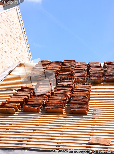 Image of renovation of a tiled roof of an old house