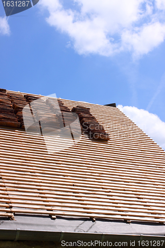 Image of renovation of a tiled roof of an old house