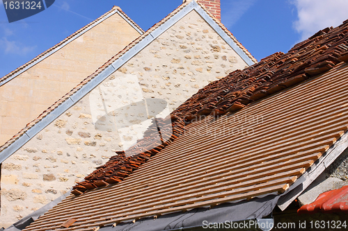 Image of renovation of a tiled roof of an old house