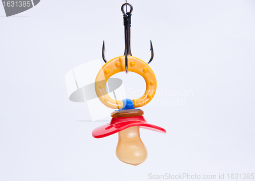 Image of infant pacifier hangs on a hook