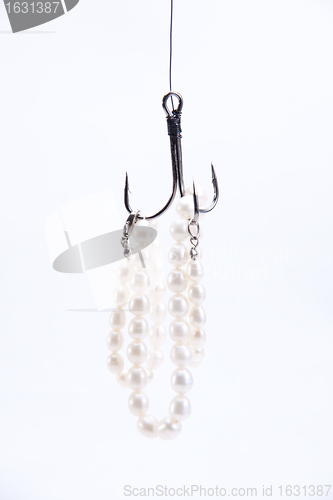 Image of jewelry made of pearls hanging on fishing hook