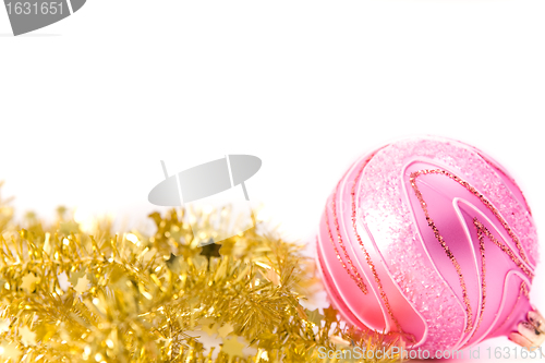 Image of golden tinsel with pink glass decoration