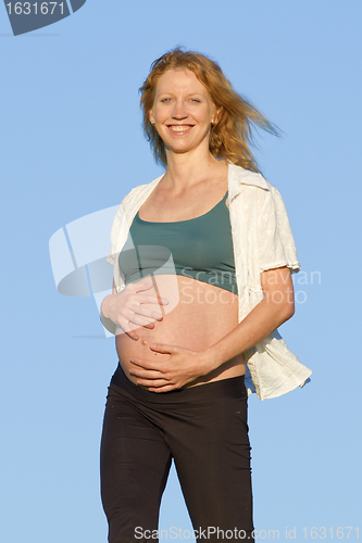 Image of pregnant woman on meadow