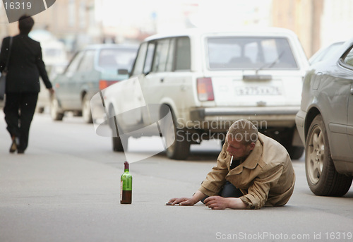 Image of Alcoholic lies on the road
