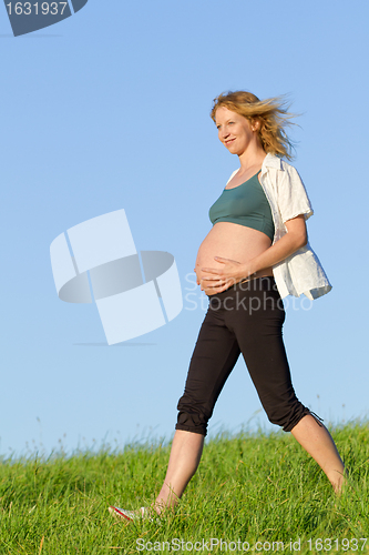 Image of pregnant woman on meadow