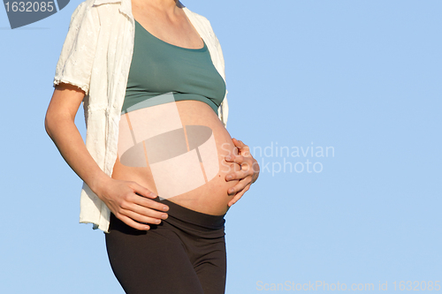 Image of pregnant woman on meadow