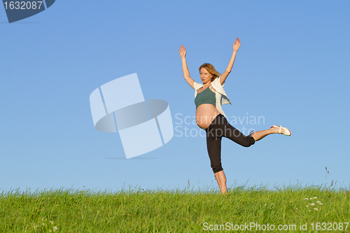 Image of pregnant woman on meadow