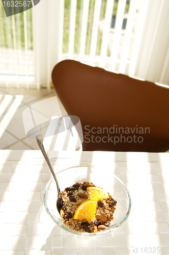 Image of Healthy muesli with orange in the morning sun