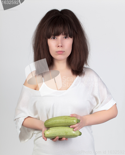 Image of The young beautiful woman with the fresh vegetables
