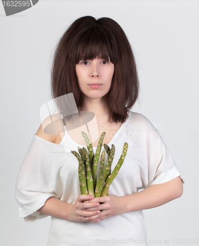 Image of The young beautiful woman with the fresh vegetables