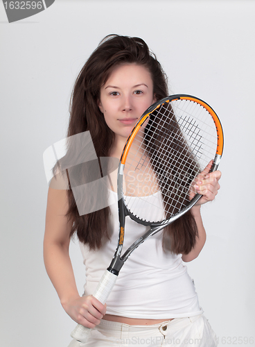 Image of Young woman with tennis racket isolated on white