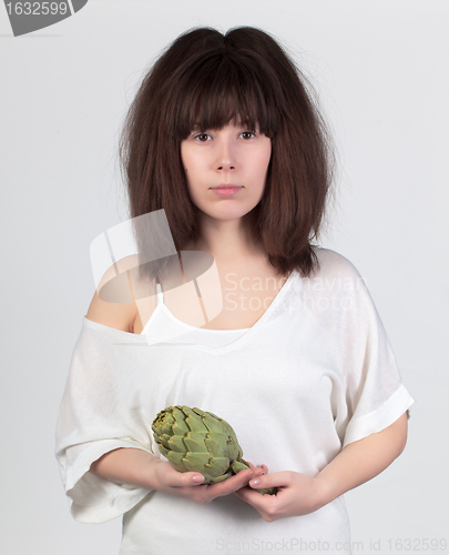 Image of The young beautiful woman with the fresh vegetables
