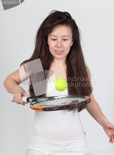 Image of Young woman with tennis racket