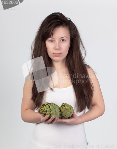 Image of The young beautiful woman with the fresh vegetables