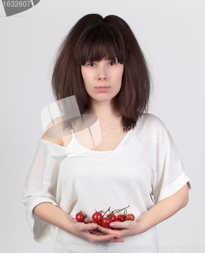 Image of The young beautiful woman with the fresh vegetables