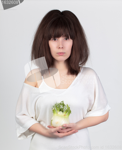 Image of The young beautiful woman with the fresh vegetables