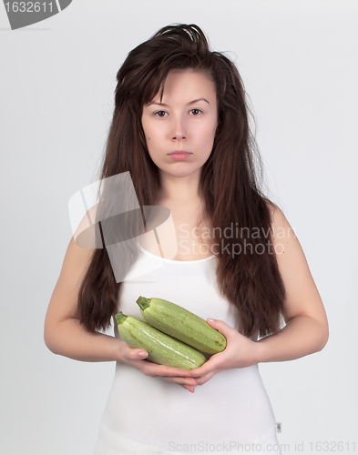 Image of The young beautiful woman with the fresh vegetables