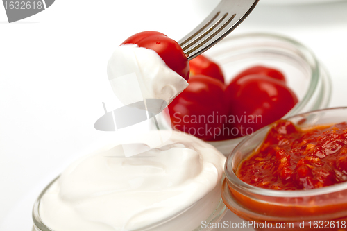 Image of Sour Cream, Catchup and tomato on fork