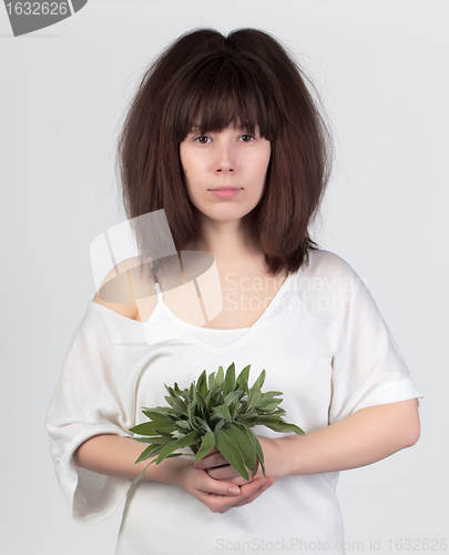 Image of The young beautiful woman with the fresh sage