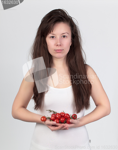 Image of The young beautiful woman with the fresh vegetables
