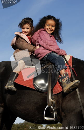 Image of two riding little girls