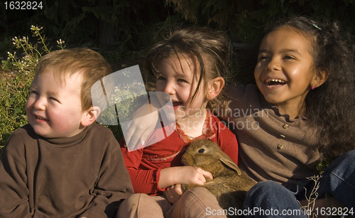 Image of three children and bunny