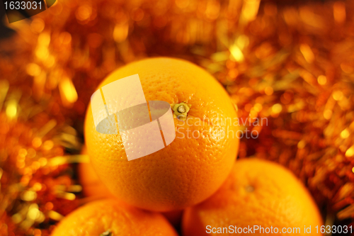 Image of orange close up on a background of twinkling garlands