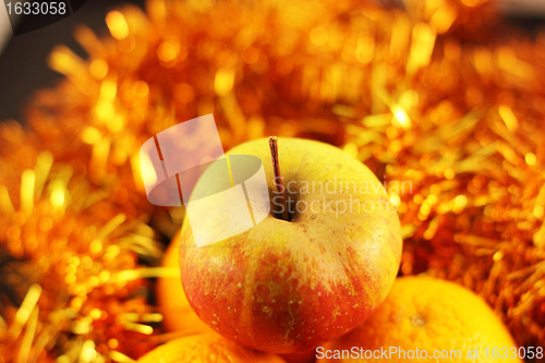Image of apple close-up on a background of twinkling garlands