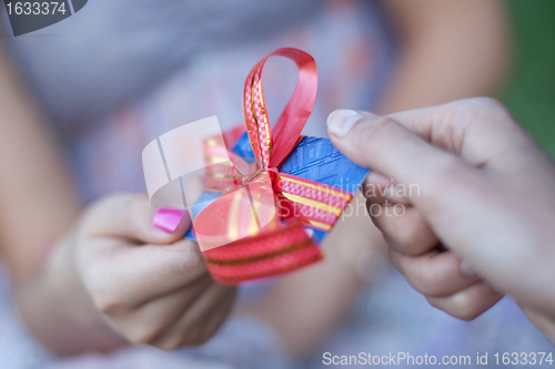 Image of Credit card with bow as gift to young woman