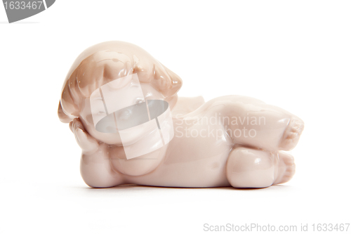 Image of figurine of angel lying on white background