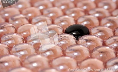 Image of black glass stone in pink glass stones