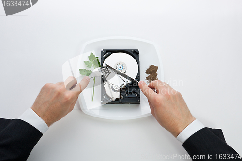 Image of hard disk cut with a knife man