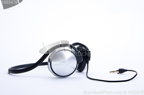 Image of headphones with plug lie on background