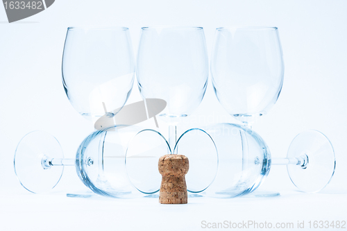 Image of glass wine stand and lie symmetrically with cork