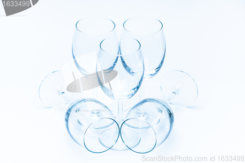 Image of Wine glasses stand and lie symmetrically