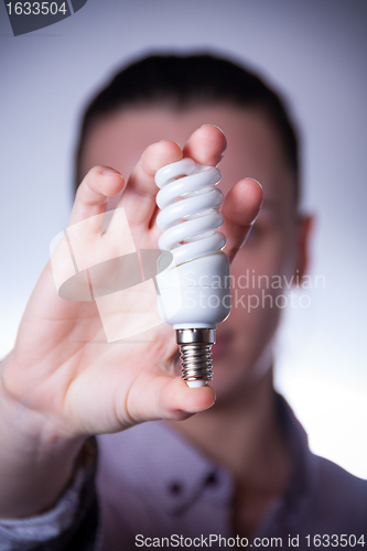 Image of person holding energy saving lamp