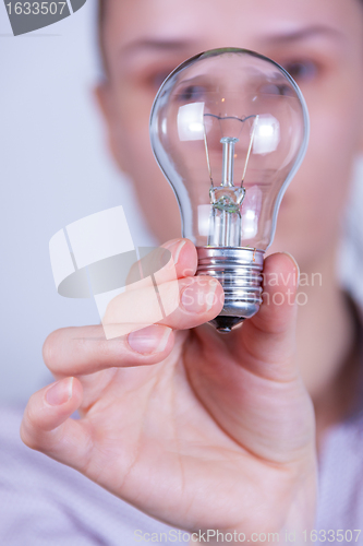 Image of woman holding electrical lamp