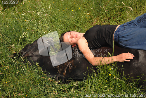 Image of horse laid down and riding girl