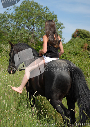 Image of young woman and horse