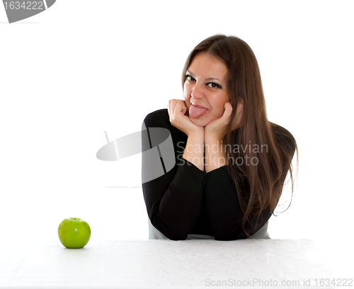 Image of girl with green apple showing tongue