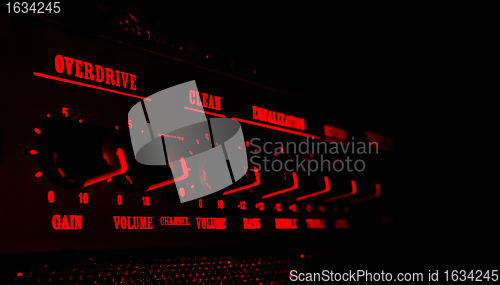 Image of guitar amplifier control panel in red light