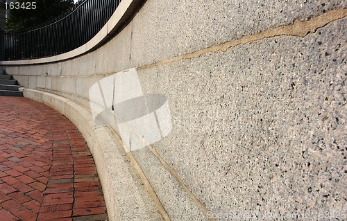 Image of Curving Cement Wall with bricks and Iron fence