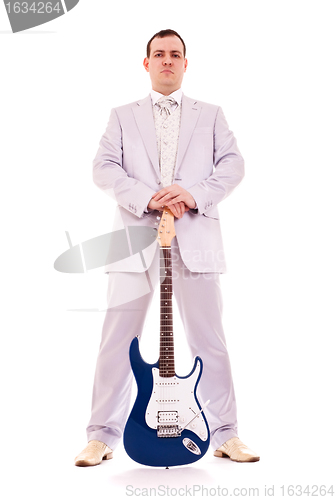 Image of man standing with electro guitar