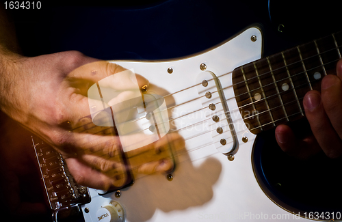 Image of guitar playing in the move