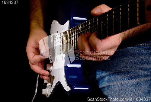 Image of guitar playing in the move