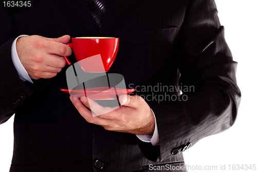 Image of man in black suit hold coffee cup