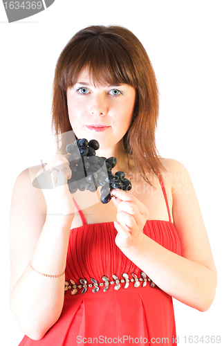 Image of beautiful girl with black grapes in hand