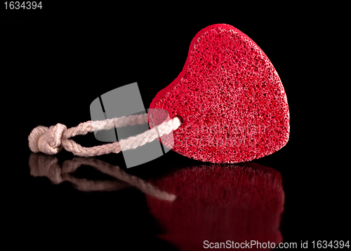 Image of red heart-shaped stone with rope